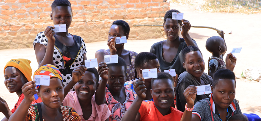 One of the women groups pose with their DIGID cards during the distribution of cash in Bukedea district.