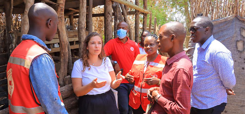 Bahati Wigingo (maroon shirt) showcases his piggery farm to Cogels and officials from URCS and Belgium Red Cross