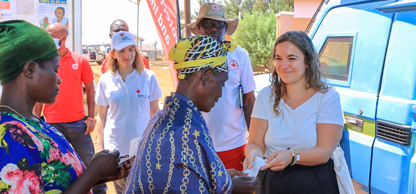 The Head of the Humanitarian Aid Unit at Ministry of Foreign Affairs Belgium – Laura Cogels (right) participating in the distribution of the non-conditional cash to the refugees in Kyangwali refugee settlement. 
