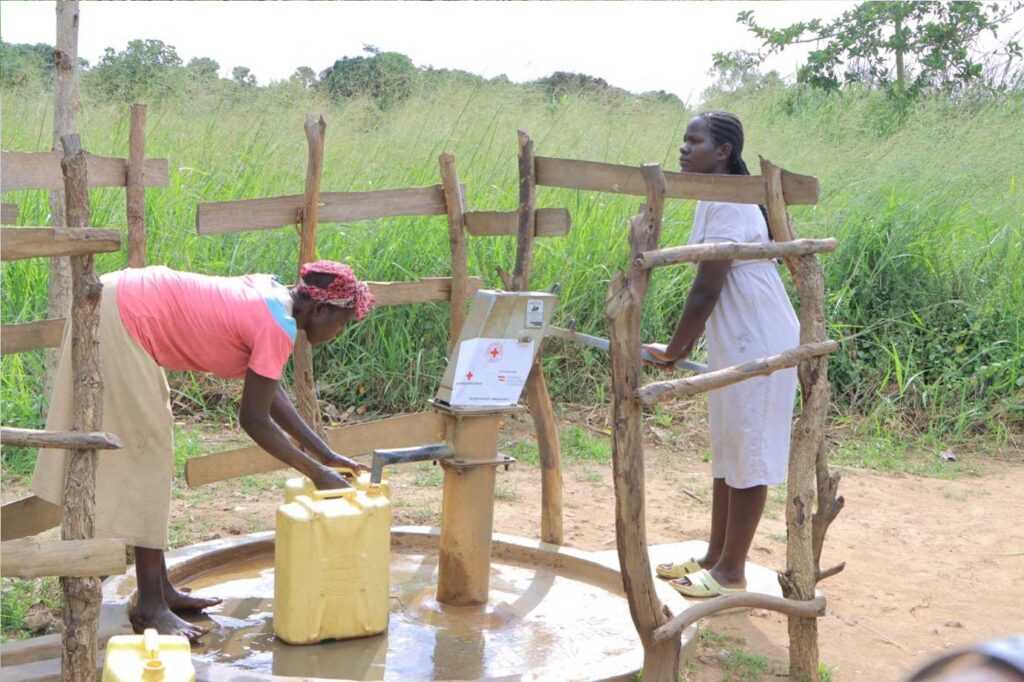 Residents of Bugantila Subcounty fetching water from one of the rehabilitated boreholes by URCS supported by the Skybird project.