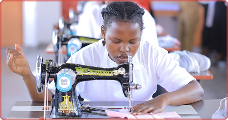 Paula Kobusigye, sewing a reusable pad at the URCS manufacturing plant in Namakwa, Mukono district.