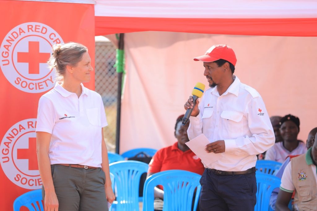Head of Austrian Red Cross Programs in the Africa, Michela Pichler together with the head of the Austria Red Cross Uganda delegation, Sylvester Bett making their remarks to the revelers during the commissioning of the Yumbe sub branch office constructed under the BIMYSAWA project.  