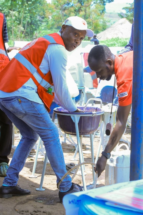 Success Bazibuha Uganda Red Cross Volunteer demonstrates how to use the Jengu handwashing facility 